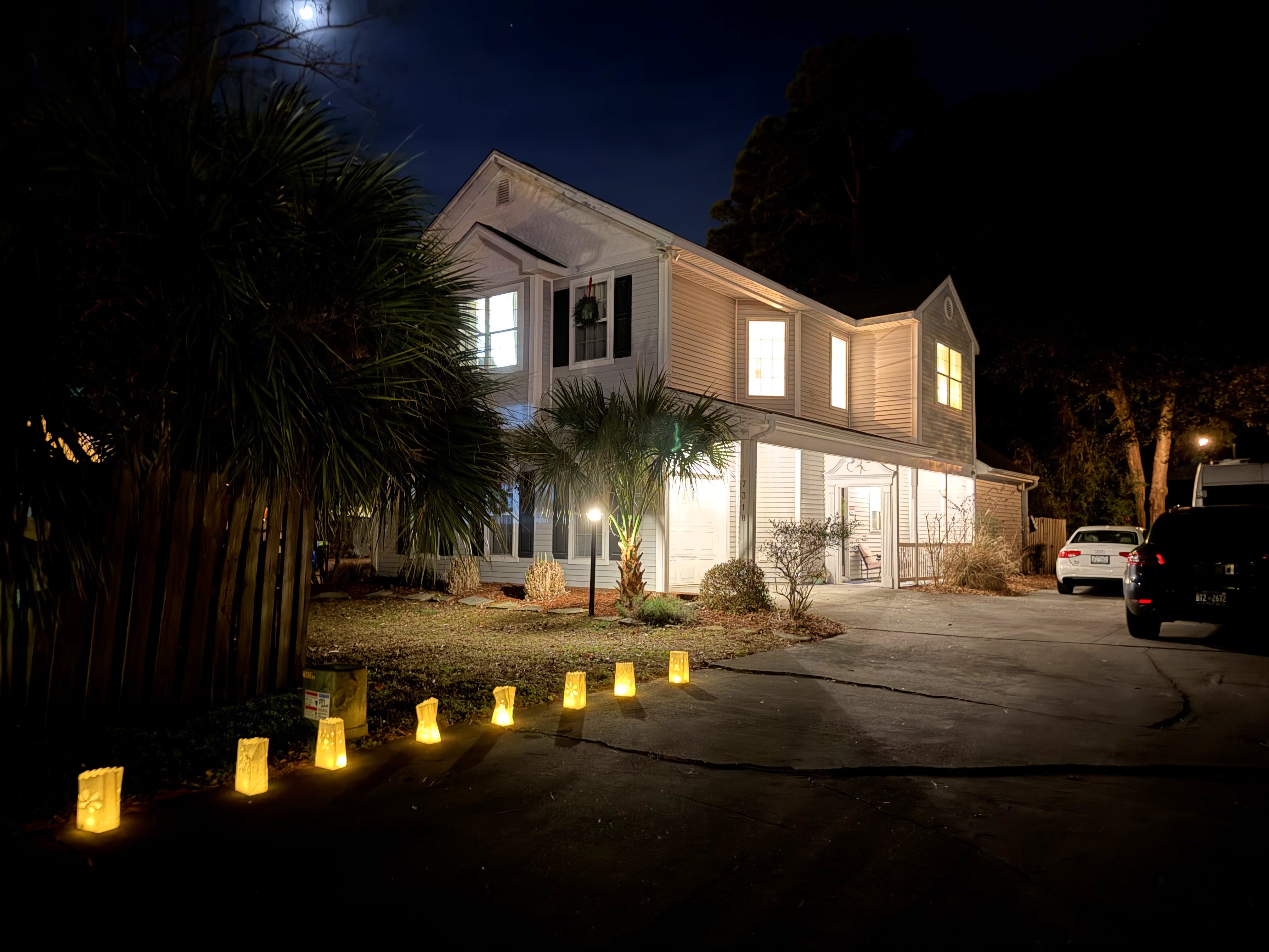 our house and driveway all lit up with luminaria on Christmas Eve, 2025