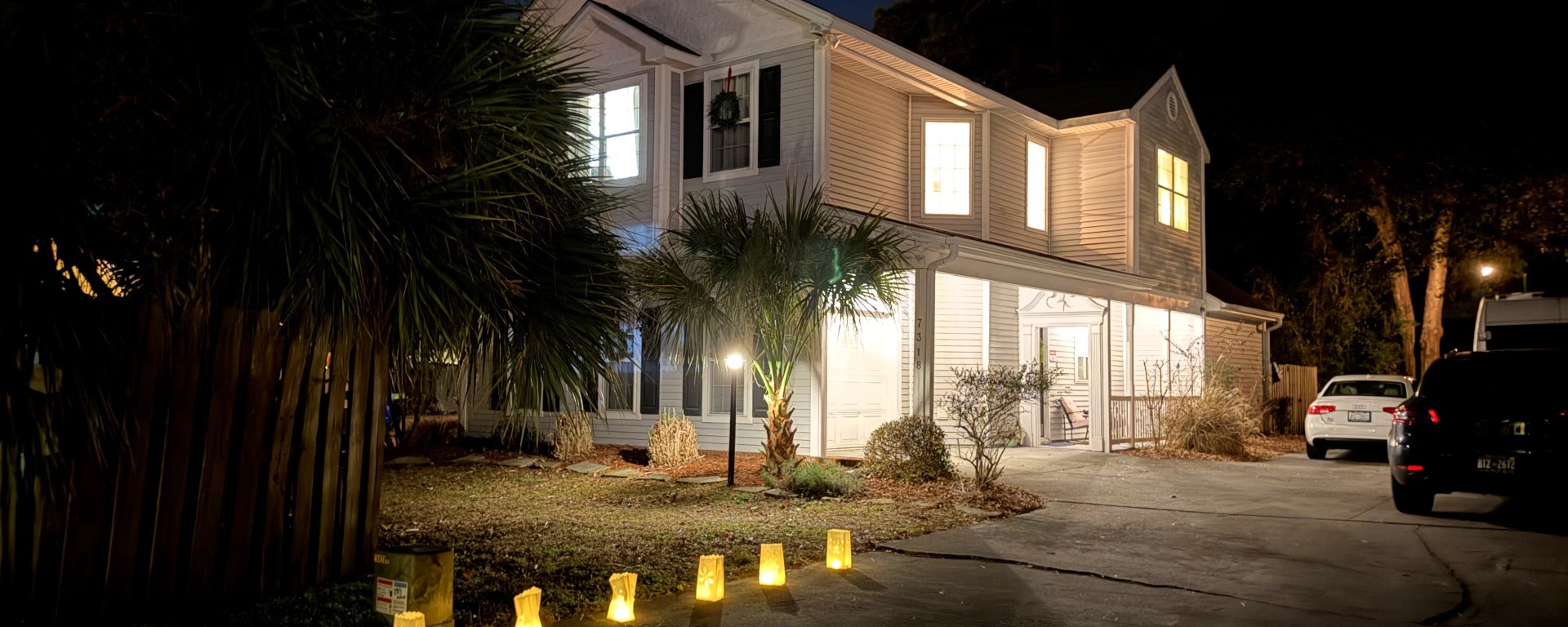our house and driveway all lit up with luminaria on Christmas Eve, 2025